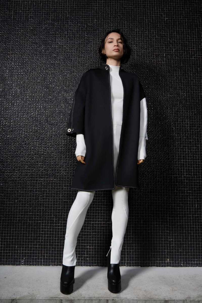 The female model wears the oversized two-tone Jules in black neoprene with white sleeves.